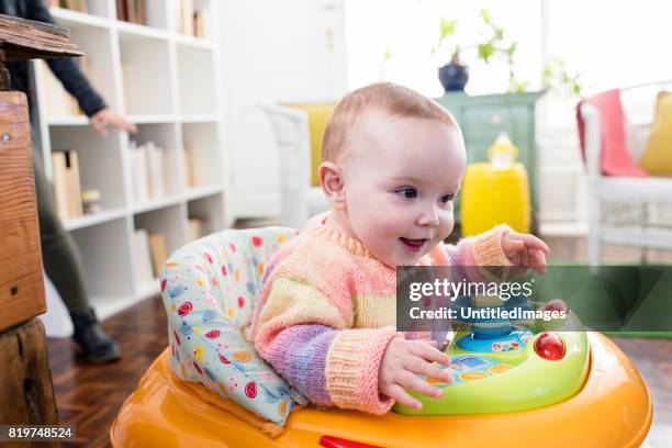 baby girl playing in walker - baby walker stock pictures, royalty-free photos & images