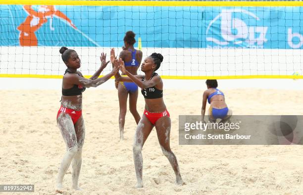 Tsyan Selvon and Ebony Williams of Trinidad And Tobago compete against Rose Mary Moise and Luduine Tebeim of Vanuatu during the Trinidad And Tobago...