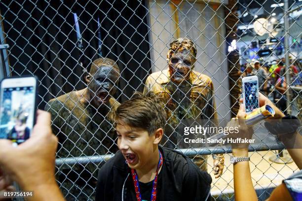 Visitors take selfies at The Walking Dead booth at Comic Con International on July 20, 2017 in San Diego, California. Comic Con International is...