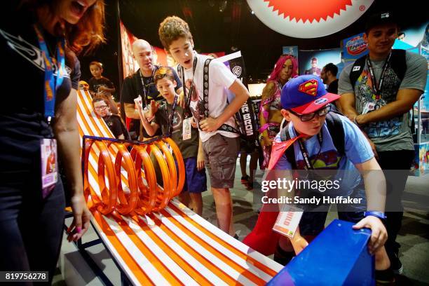 Kids engage in a box car race at the Mattell booth during Comic Con International on July 20, 2017 in San Diego, California. Comic Con International...