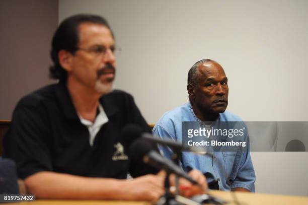 Former professional football player O.J. Simpson, center, listens as Bruce Fromong testifies during a parole hearing at Lovelock Correctional Center...