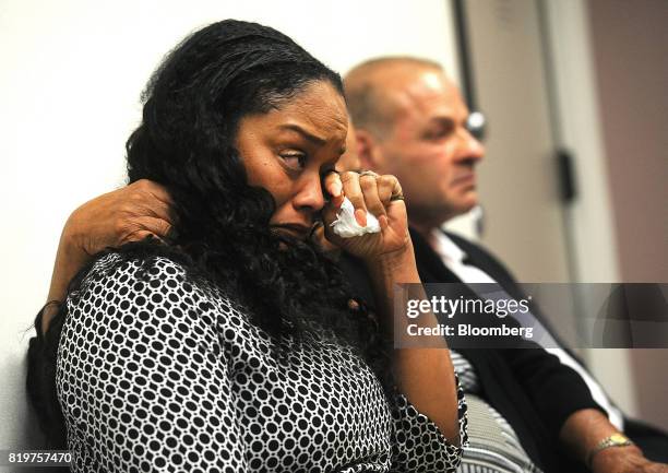 Arnelle Simpson, daughter of former professional football player O.J. Simpson, center, reacts during his parole hearing at Lovelock Correctional...