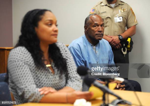 Former professional football player O.J. Simpson, center, listens as his daughter Arnelle Simpson testifies during a parole hearing at Lovelock...