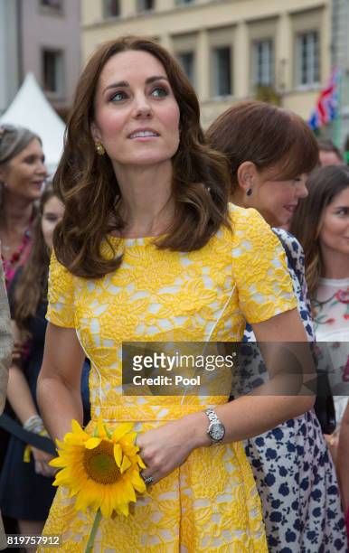 Catherine, Duchess of Cambridge tours a traditional German market in the Central Square during an official visit to Poland and Germany on July 20,...