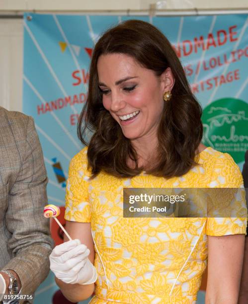 Catherine, Duchess of Cambridge makes sweets as they tour of a traditional German market in the Central Square during an official visit to Poland and...