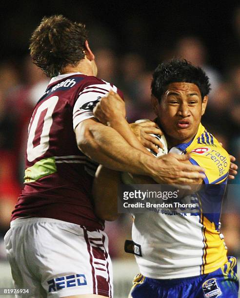 Taulima Tautai of the Eels is tackled by Josh Perry of the Sea Eagles during the round 19 NRL match between the Manly Warringah Sea Eagles and the...