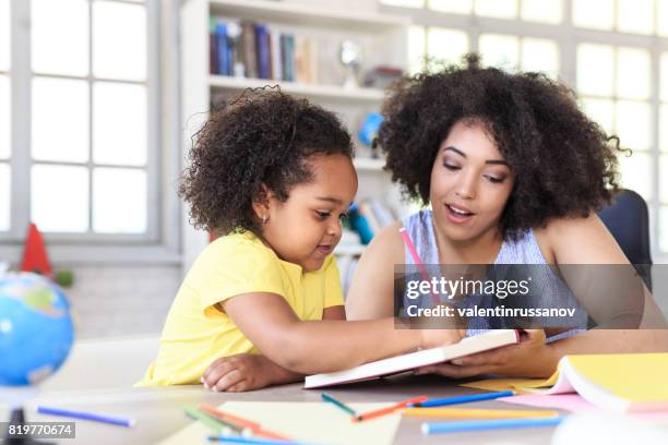 teacher learning little girl - parent teacher classroom stock pictures, royalty-free photos & images