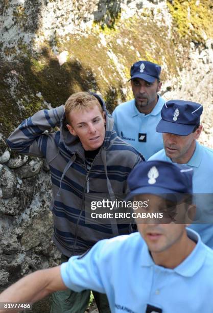 Italian rider Riccardo Ricco of the Spanish Saunier-Duval cycling team is escorted by French policemen to the Prosecutor's office on July 18, 2008 in...