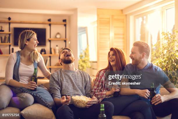 playful man catching popcorn with his mouth while his friends are watching. - catching food stock pictures, royalty-free photos & images