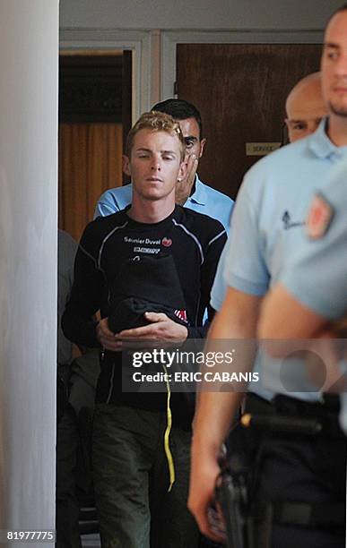 Italian rider Riccardo Ricco of the Spanish Saunier-Duval cycling team is escorted by French policemen as he arrives to the office of Prosecutor's...