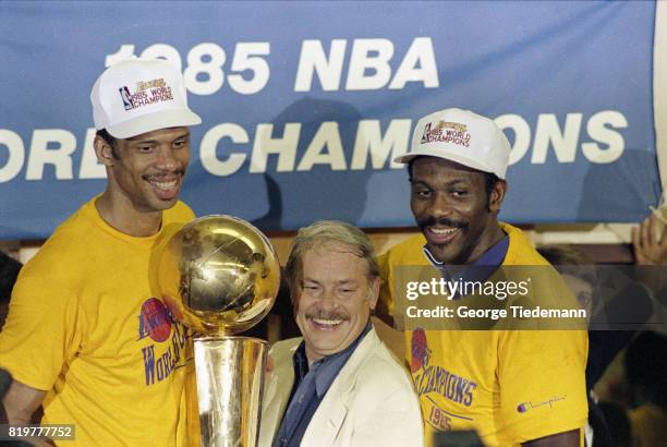 Finals: Los Angeles Lakers owner Jerry Buss victorious holding Larry O'Brien NBA Championship Trophy with Kareen Abdul-Jabbar and Bob McAdoo after...