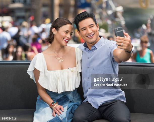 Paula Patton and Mario Lopez take a selfie together at "Extra" at Universal Studios Hollywood on July 20, 2017 in Universal City, California.