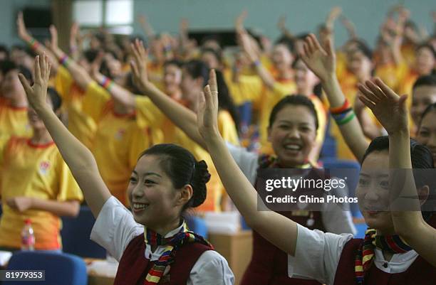 Stewardesses of Air China cheer during the establishment ceremony of the Gold Phoenix Cheering Squad on July 18, 2008 in Beijing, China. The team...