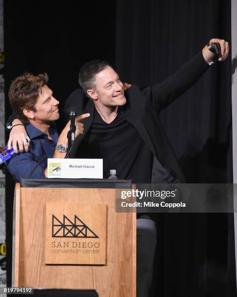 Michael Trucco and Tahmoh Penikett take a selfie onstage at the "Medinah" World Premiere Sneak Peek during Comic-Con International 2017 at San Diego...