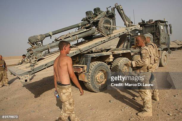 British soldiers from the 13 Air Assault Support Regiment load a piece of artillery on a truck in FOB Dywer as they prepare to go back to their base...