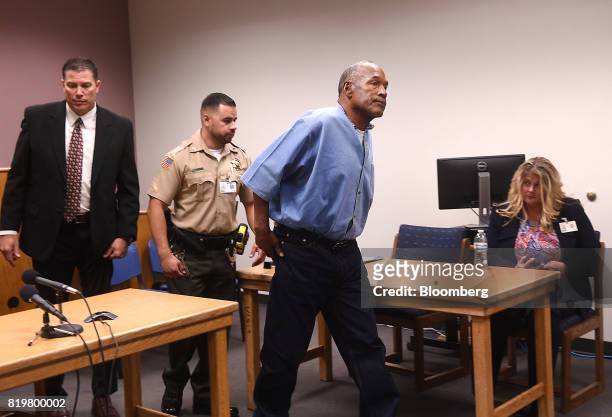 Former professional football player O.J. Simpson, center, exits after a parole hearing at Lovelock Correctional Center in Lovelock, Nevada, U.S., on...