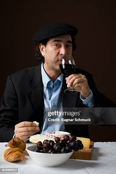 stereotypical french man with stereotypical french food - stereotypical foto e immagini stock