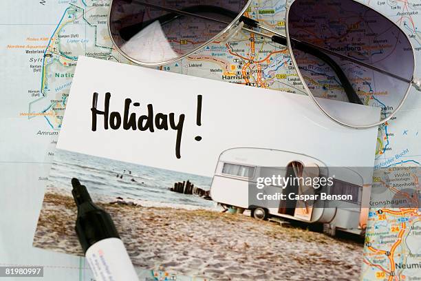 a map, sunglasses, and a postcard - postkarte stock-fotos und bilder