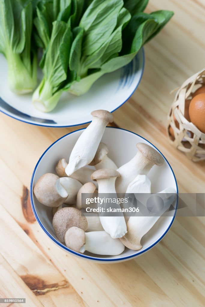 Clear light organic Japanese mushroom on wooden table