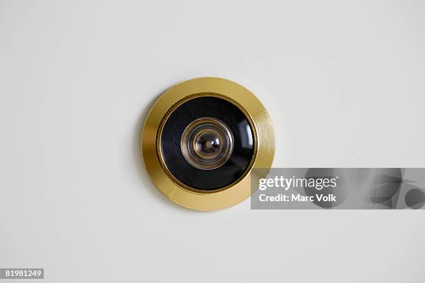 close-up of a door peephole - peephole stock pictures, royalty-free photos & images