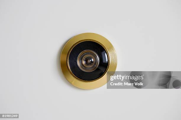 close-up of a door peephole - door peep hole stock pictures, royalty-free photos & images