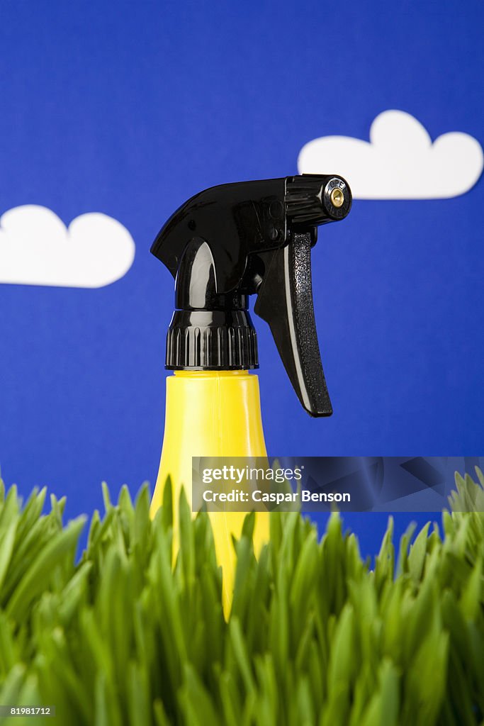 A spray bottle in grass