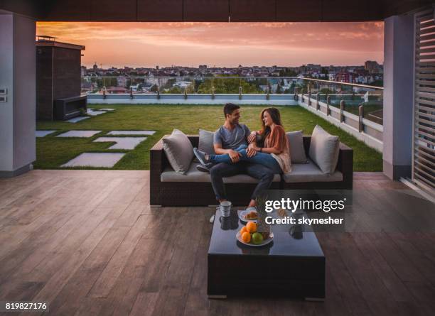 loving couple enjoying in morning conversation on a balcony. - penthouse stock pictures, royalty-free photos & images