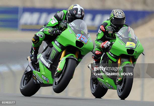 Australian MotoGP rider Anthony West passes his teammate US Jamie Hacking on their Kawasaki during the Free Practice of the Red Bull US Grand Prix in...