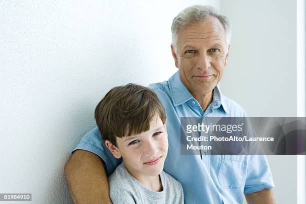 grandfather and grandson smiling at camera together, portrait - enkel object stock-fotos und bilder