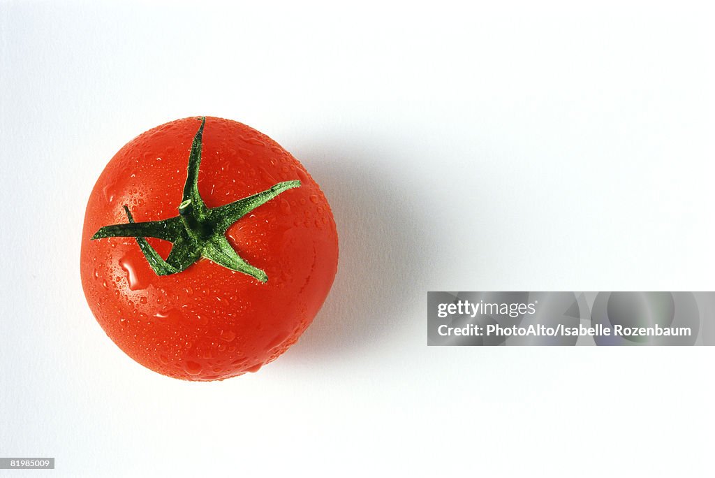 Tomato with droplets of water, close-up, viewed from directly above