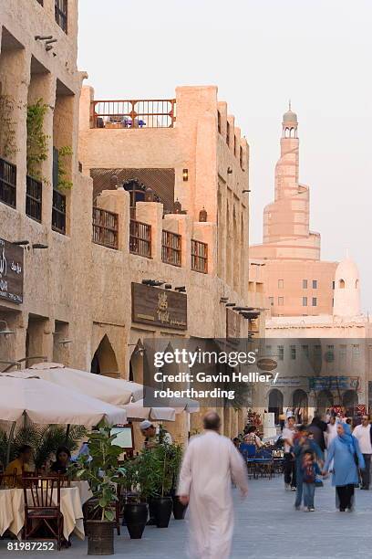 the restored souq waqif looking towards the spiral mosque of the kassem darwish fakhroo islamic centre based on the great mosque in samarr in iraq, doha, qatar, middle east&#10; - iraaks stockfoto's en -beelden