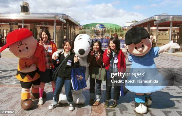 Visitors meet characters from the cartoon "Peanuts" during a pre-opening preview of Universal Studios March 29, 2001 in Osaka, Japan. Although the...