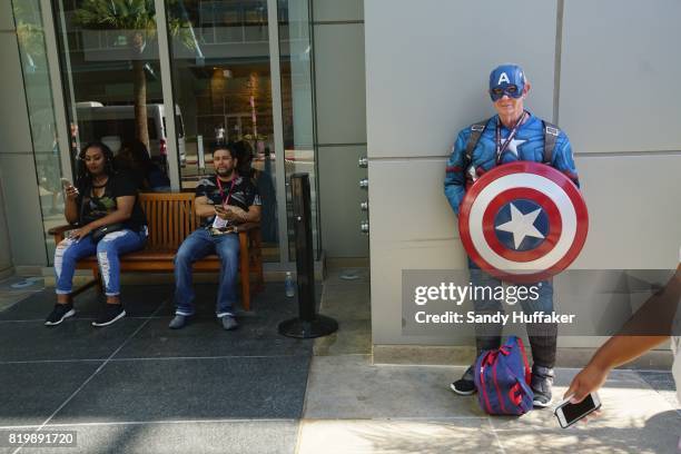 Herb Walker dressed as Captain America stands in the Gaslamp Quarter across from the San Diego Convention Center during Comic Con International in...