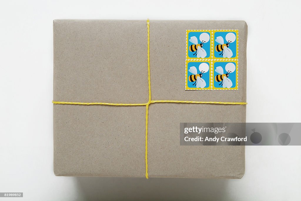 Parcel tied with yellow string, close up