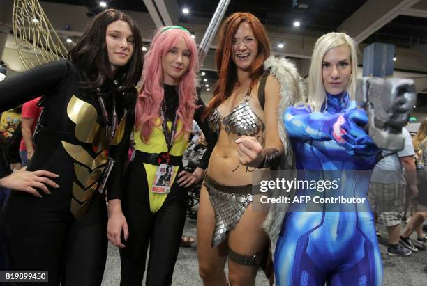 From left, women play the parts of Wasp from Marvel Comics, Pixie from X-Men, Red Sonja from Marvel Comics and Samus from Nintendo during Comic-Con...