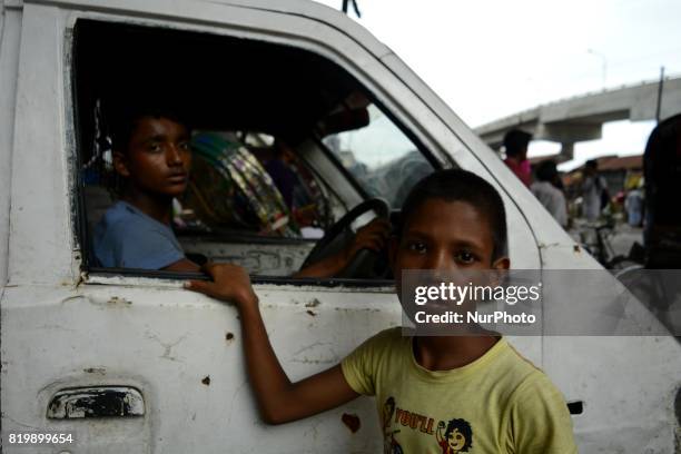 From left, Christy , Rony look at the camera during a traffic signal on Thursday , July, 20 2017 in Dhaka, Bangladesh. Christy has been working as a...