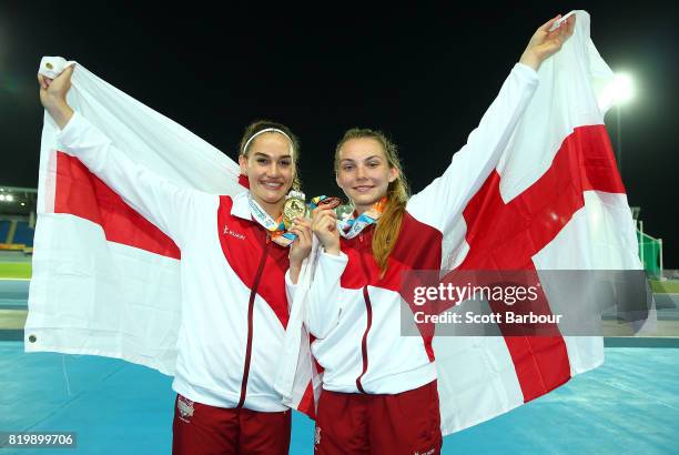 Lucy Hadaway and Holly Mills of England celebrate after winning medals after competing in the Girls Long Jump Final during the Athletics on day 3 of...