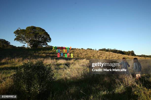 Festival goers walk towards a Splendour In The Grass sign during Splendour in the Grass 2017 on July 21, 2017 in Byron Bay, Australia.