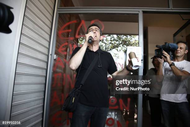 Unionist shouts slogans at the entrance of Greek Tourism Confederation during a protest march of tourism and catering workers in central Athens, on...