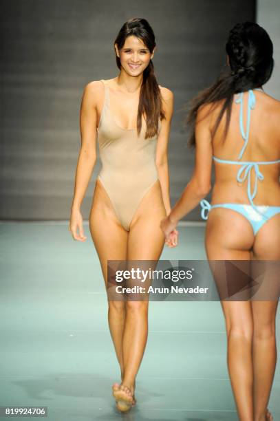 Model walks the runway during Courtney Allegra at Miami Swim Week Art Hearts Fashion at FUNKSHION Tent on July 20, 2017 in Miami, Florida.