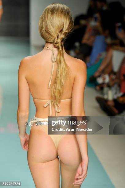 Model walks the runway during Courtney Allegra at Miami Swim Week Art Hearts Fashion at FUNKSHION Tent on July 20, 2017 in Miami, Florida.