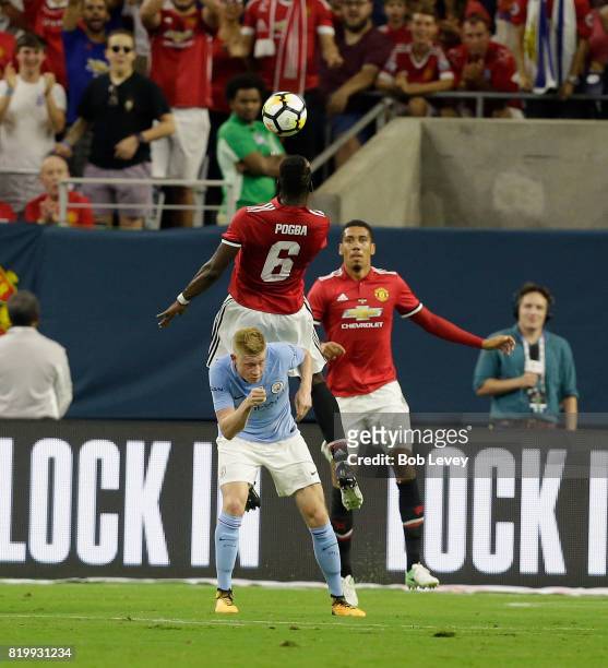 Manchester United midfielder Paul Pogba heads the ball as he goes over Manchester City midfielder Kevin De Bruyne at NRG Stadium on July 20, 2017 in...