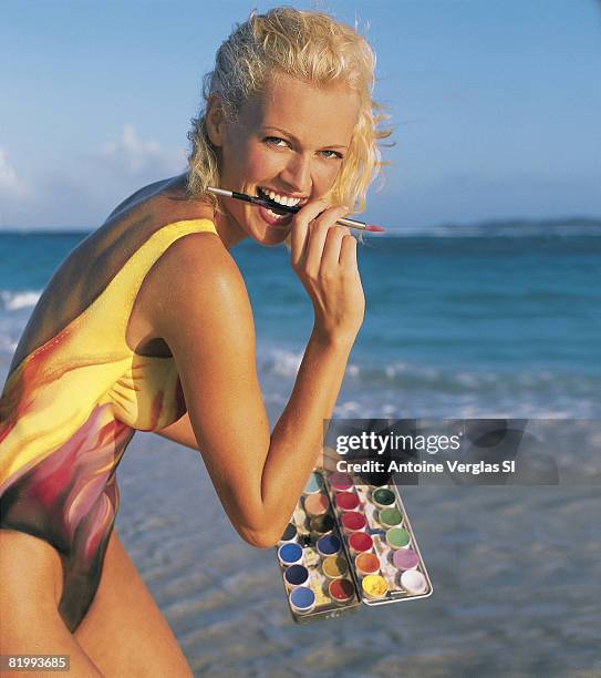 Swimsuit Issue 1999: Model Sarah O'Hare poses for the 1999 Sports Illustrated swimsuit issue on February 1, 1999 on Necker Island. Body painting by...