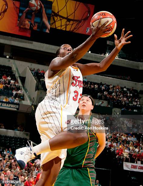 Ebony Hoffman of the Indiana Fever lays the ball up over Katie Gearlds of the Seattle Storm at Conseco Fieldhouse on July 18, 2008 in Indianapolis,...