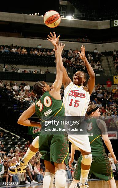 Tan White of the Indiana Fever shoots over Tanisha Wright of the Seattle Storm at Conseco Fieldhouse on July 18, 2008 in Indianapolis, Indiana. NOTE...
