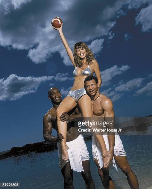 Swimsuit Issue 2001: Model Heidi Klum and football players Eric Moulds and Rod Woodson pose for the 2001 Sports Illustrated swimsuit issue on...