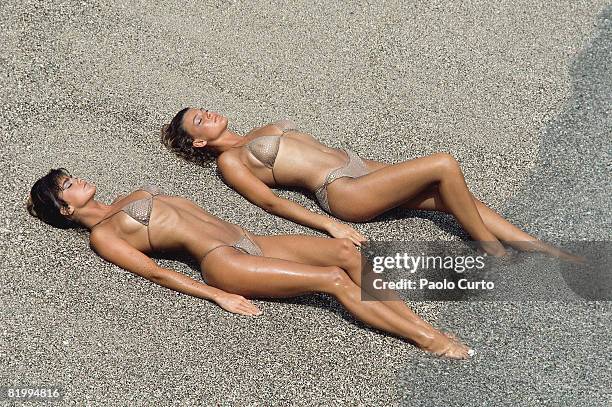 Swimsuit Issue 1984: Models Kathy Ireland and Jean Pelton pose for the 1984 Sports Illustrated Swimsuit issue on December 16, 1983 in Aruba. CREDIT...