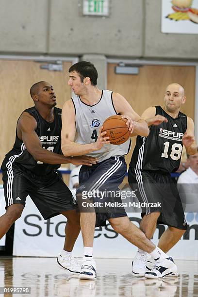 Kosta Koufos of the Utah Jazz drives past Brian Morrison of the San Antonio Spurs at the Salt Lake Community College Campus on July 18, 2008 in Salt...