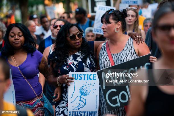 Valerie Castile, center, mother of Philando Castile who was killed by a police officer last year, marches in memory of Justine Damond on July 20,...