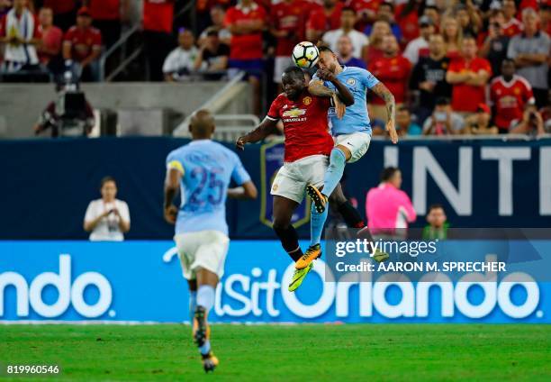 Manchester City defender Nicolas Otamendi hits a header as Manchester United forward Romelu Lukaku defends during the International Champions Cup...